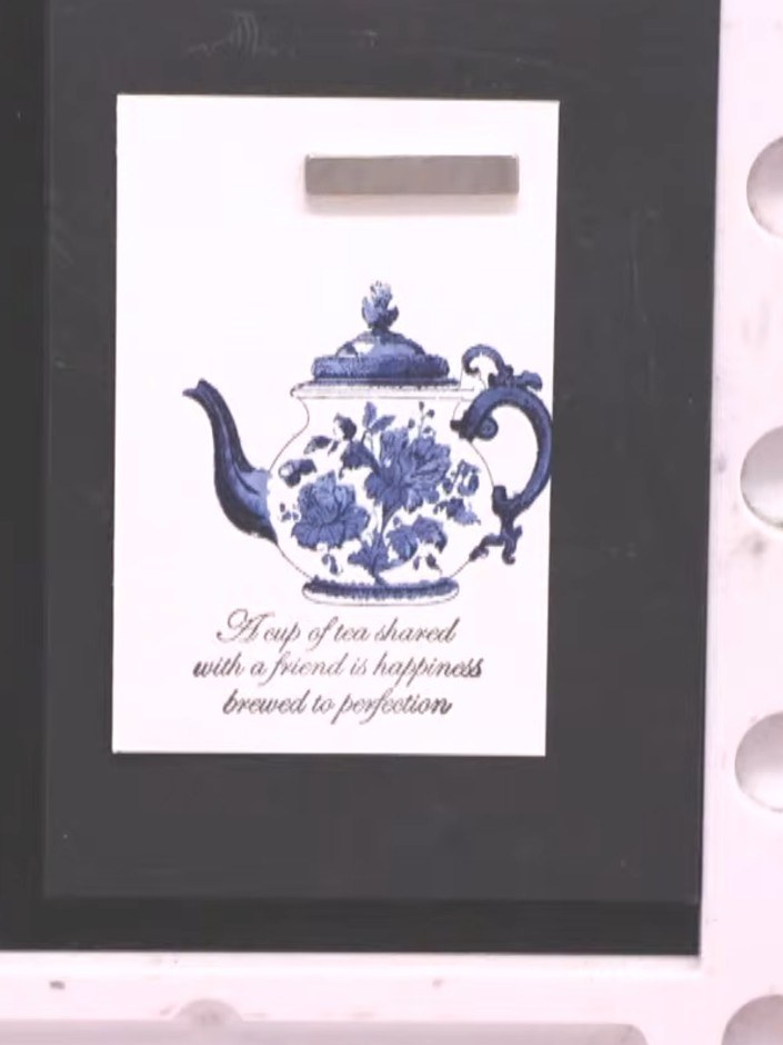 Step 8: Using a damp brush with a light grey or heather ink, paint a soft shadow underneath the teapot to ground the i