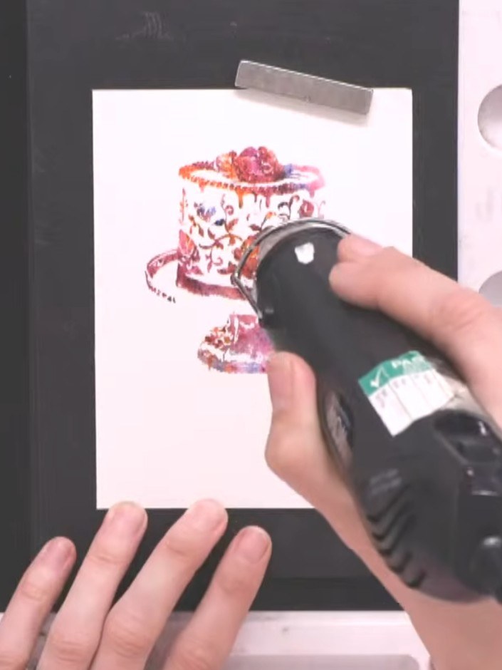 Step 6: Use a heat gun to dry the stamped image thoroughly. Hold the heat gun a few inches above the card and move it 