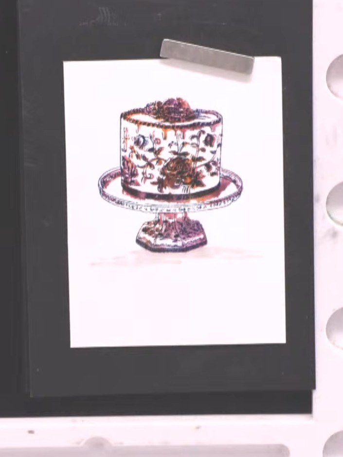 Step 8: Paint a shadow around the base of the cake using diluted grey paint to make it appear grounded and three-dimen