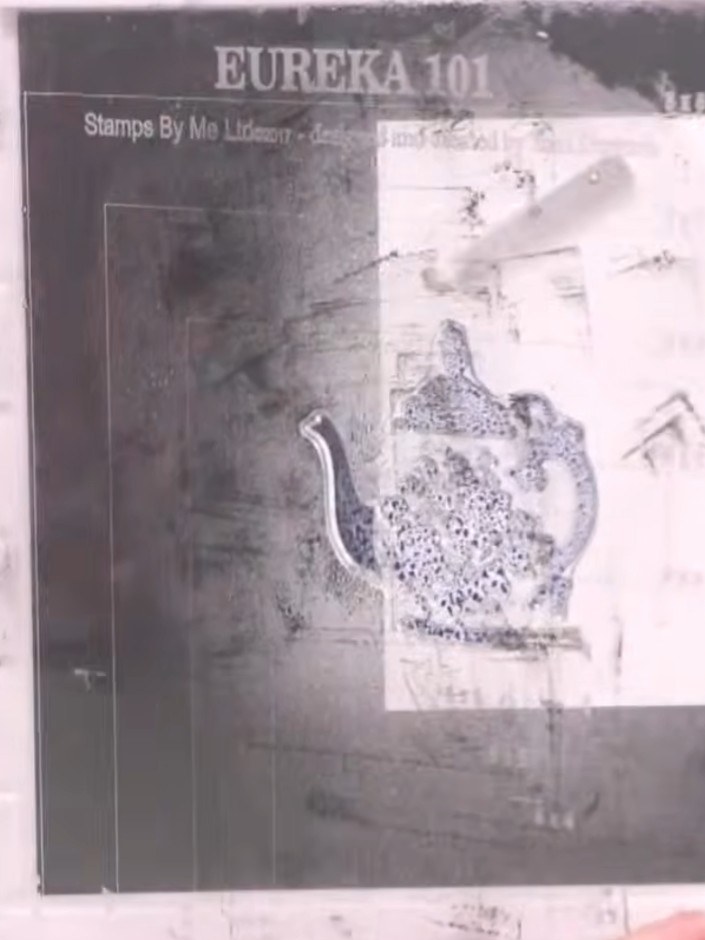 Step 4: Spray the stamped teapot image three times with water to activate the ink and create a watercolour effect. All