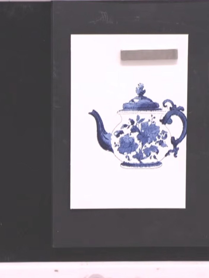 Step 8: Stamp the teapot image onto white card using the blue ink, pressing firmly to transfer the fine china pattern 