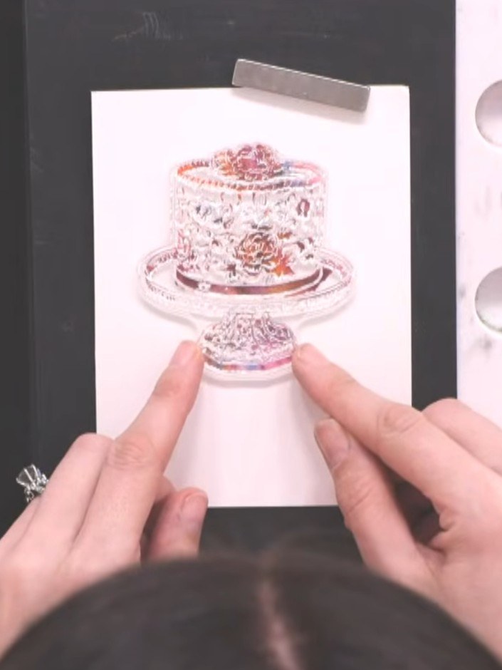 Step 6: Position the detail stamp over the solid cake image on your card blank, using the packet as a guide to ensure 