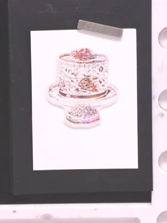 Step 7: Stamp the cake image onto white card using teal ink. Press firmly and evenly to ensure all the decorative deta