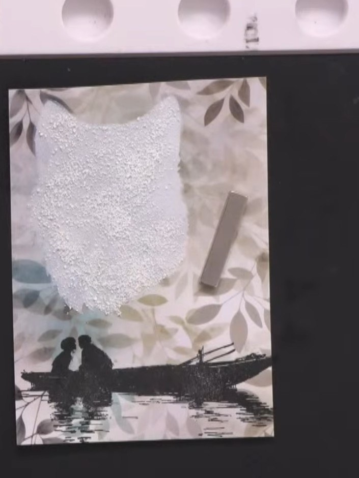 Step 5: Layer the black banner tails behind the white glittered sentiment piece using adhesive. Position them evenly t