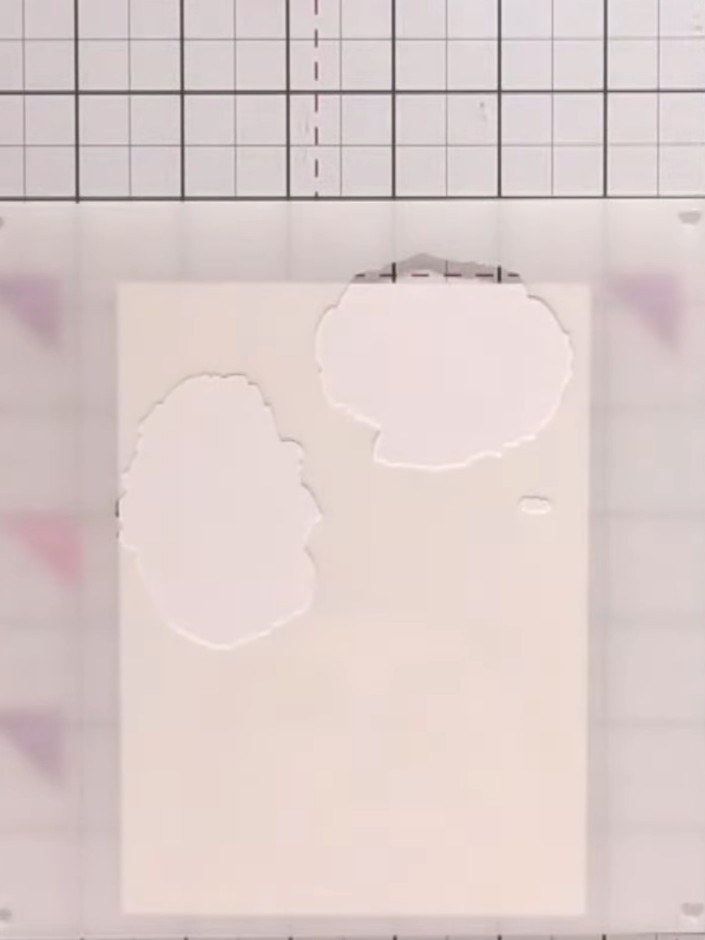 Step 3: Using a red ink pad, apply ink to the first poppy stencil with a pouncing motion, pressing the pad firmly onto
