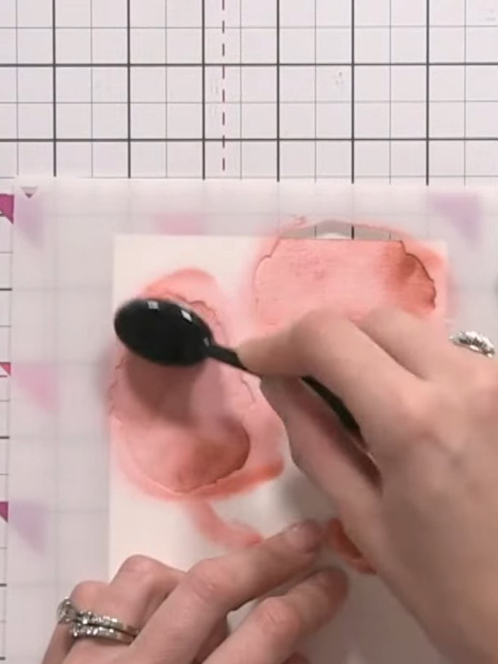 Step 6: Apply red ink to stencil number two using a gentle pouncing technique. Use light dabbing motions to avoid drag