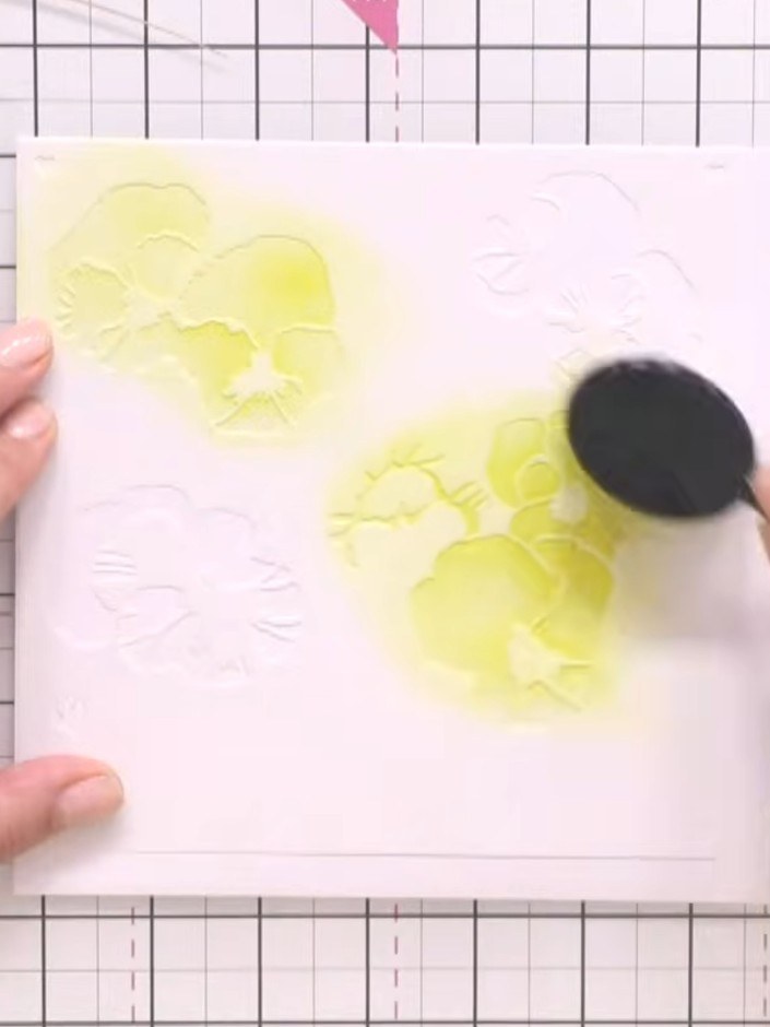 Step 4: Continue layering stencils three through six over your card, using the blending tool to apply yellow, pink, pu