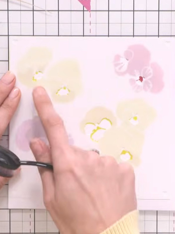 Step 5: Using the final stencil layer, ink the flower centres with a darker shade such as black or dark green ink to a
