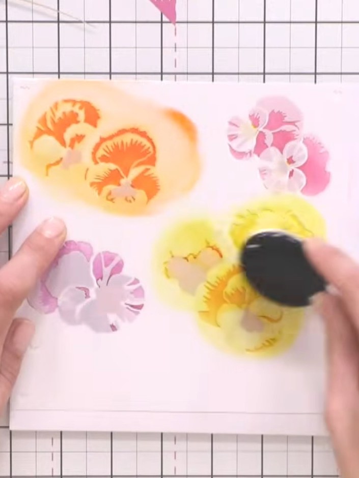 Step 6: Using a blending brush, apply a lighter teal ink shade to the green leaves, blending gently to soften the appe