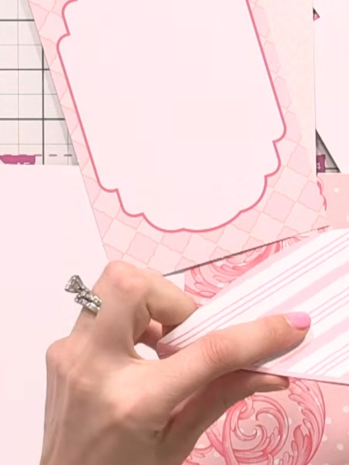 Step 4: Position a decorative striped paper strip across the front of the album. Secure it in place with adhesive, ens