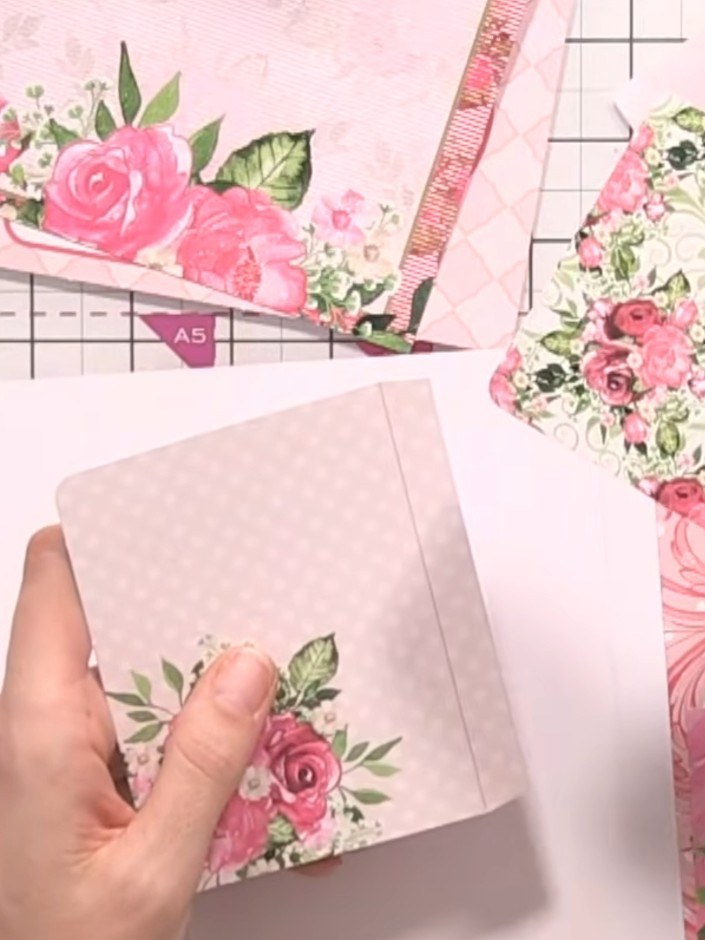 Step 5: Glue the pocket elements inside the album pages at varying heights to create layered storage. Position the flo