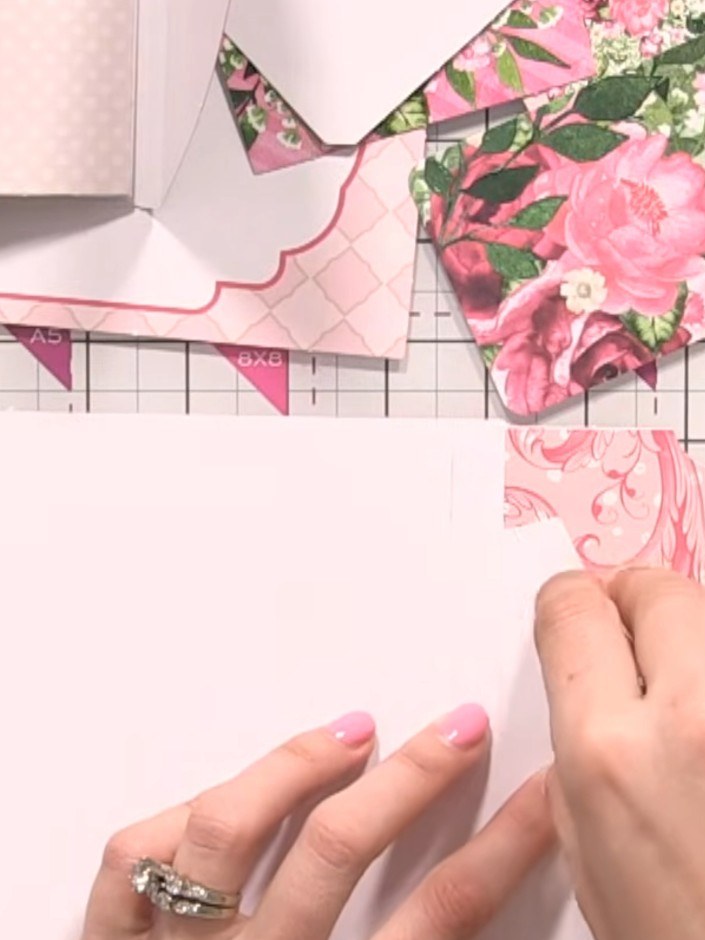 Step 6: Apply glue to the back of your mat layer where the hinge will sit. Position the interactive flap page behind t