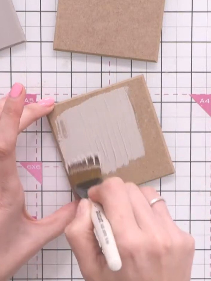 Step 1: Place the MDF coaster on a protective surface and apply your first base coat of paint using a graduate brush. 