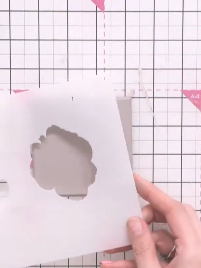 Step 5: Position the first layer of the Classic Rose stencil on the MDF coaster. Hold it steady with your hand to keep