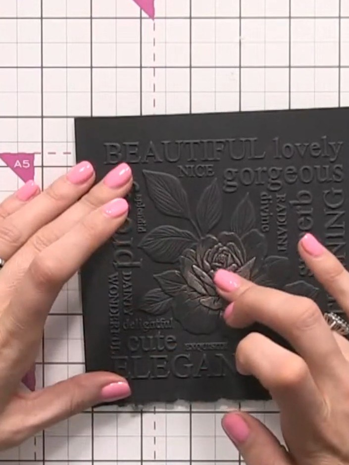 Step 4: Using your ring finger, gently tap and swipe the copper gilding wax over the embossed rose petals on the black