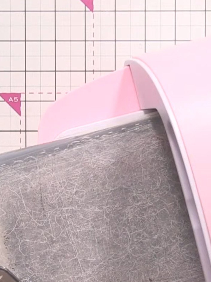 Step 1: Place your white card stock into the embossing machine with the tree embossing folder. Run it through the mach