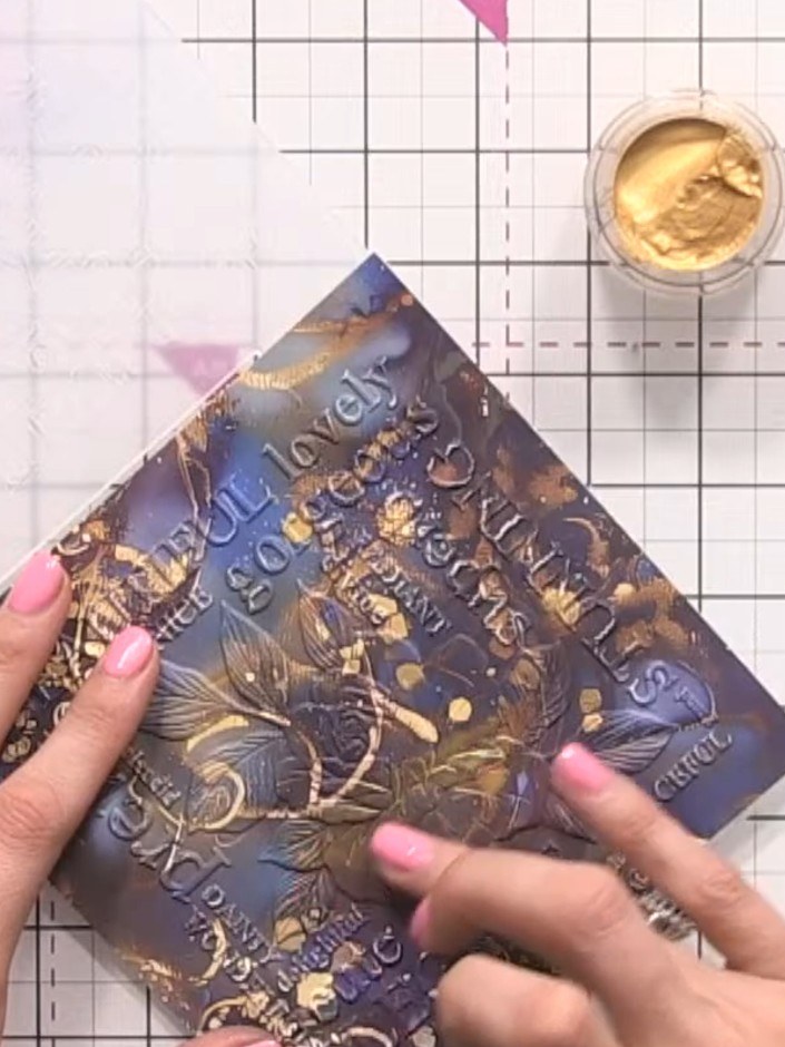 Step 4: Apply antique gold gilding wax to the bottom half of the embossed rose design on your paper. Use your finger t