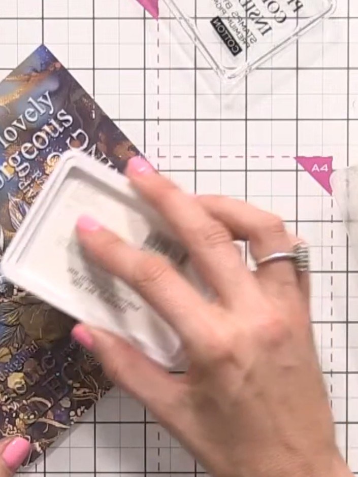 Step 5: Apply white ink pad to the top half of the embossed rose design for contrast. Use a dabbing motion to ensure e