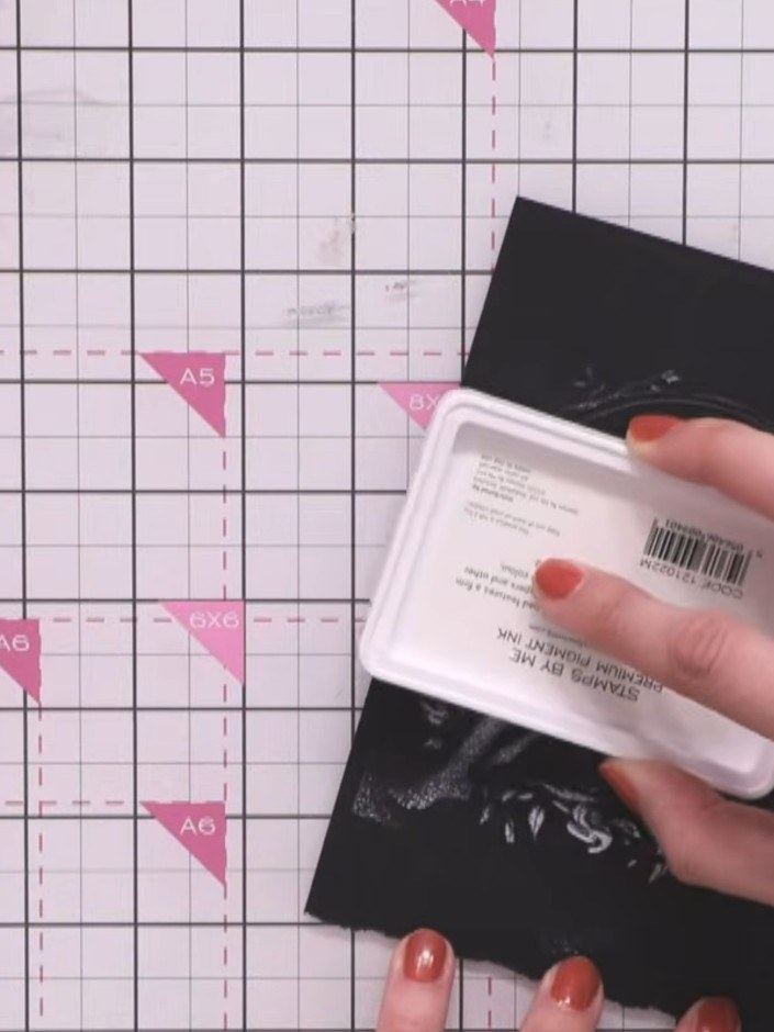 Step 5: Apply white ink to the embossed image using the ink pad, ensuring you get ink into all the corners and details