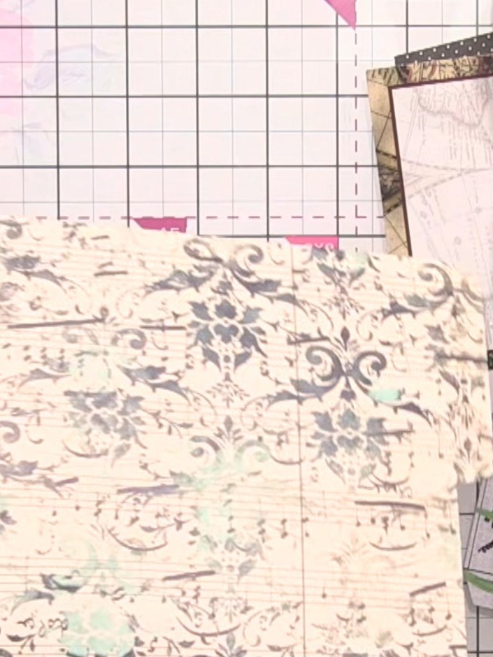 Step 3: Take a page system piece that folds shut. Score along the dark printed lines visible on the decorative paper t