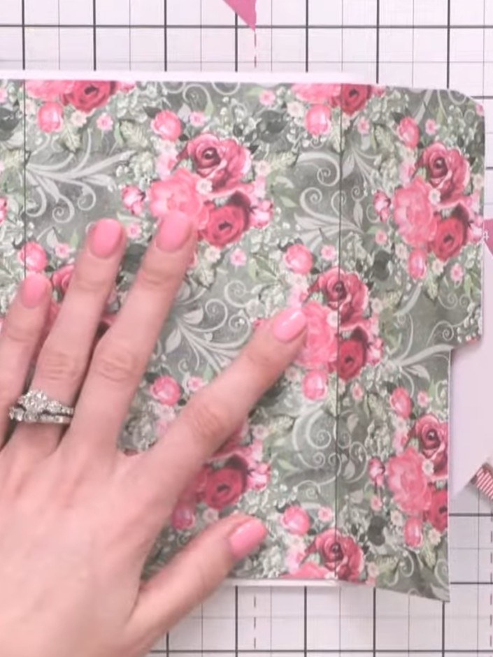 Step 6: Score and fold the floral patterned pocket pieces along the marked lines to create the pocket folds. Press fir
