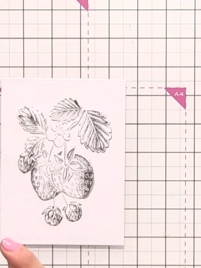 Step 3: Place a piece of scrap card underneath your stamped strawberry design. This prevents the ink from pooling on h