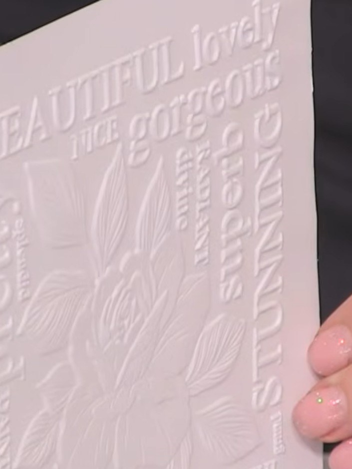 Step 2: Stamp the rose stamp onto the embossed card using black pigment ink, pressing firmly to ensure the ink capture