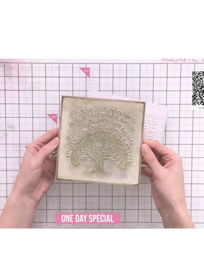 Step 3: Remove the card from the embossing folder to reveal the fully inked embossed design with the tree motif and te