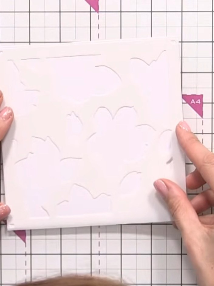 Step 1: Place the first numbered stencil (number one) onto your 6x6 white card blank, positioning it carefully and ens