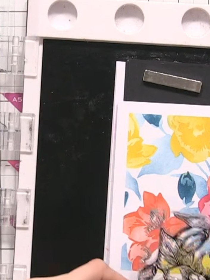 Step 5: Position the magnolia stamp over your stencilled floral design. Stamp twice using the black ink pad to create 