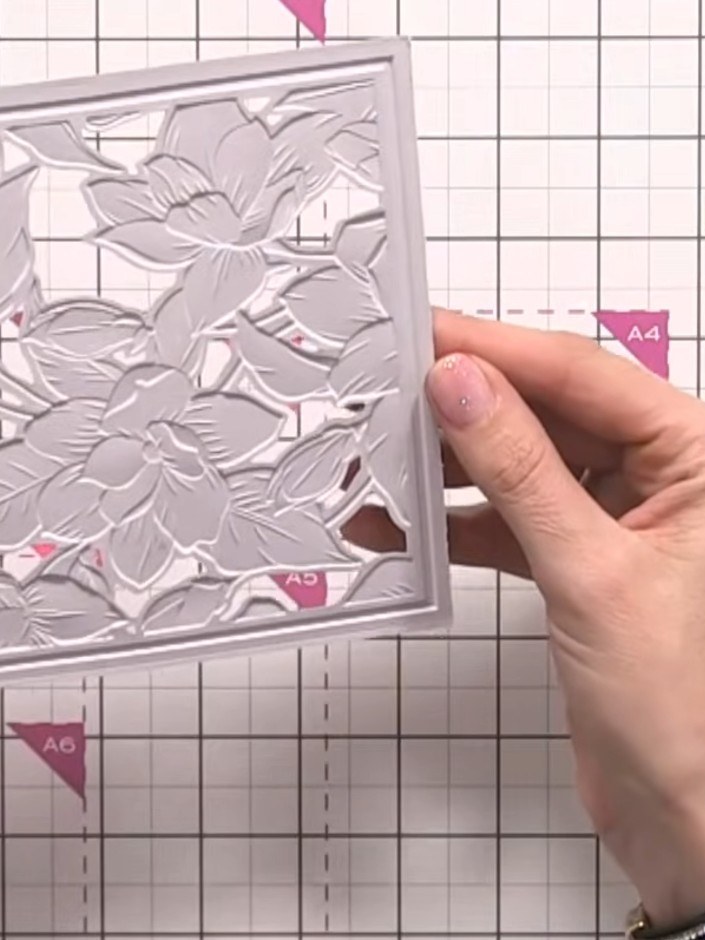 Step 8: Apply Stella paste gently to the fourth stencil area on the embossed card, working carefully around the raised
