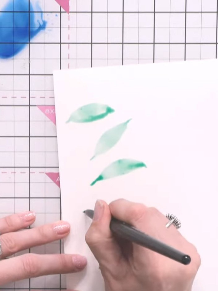 Step 4: While the first colour is still wet, drop a second colour (such as teal) into the wet ink to create instant di