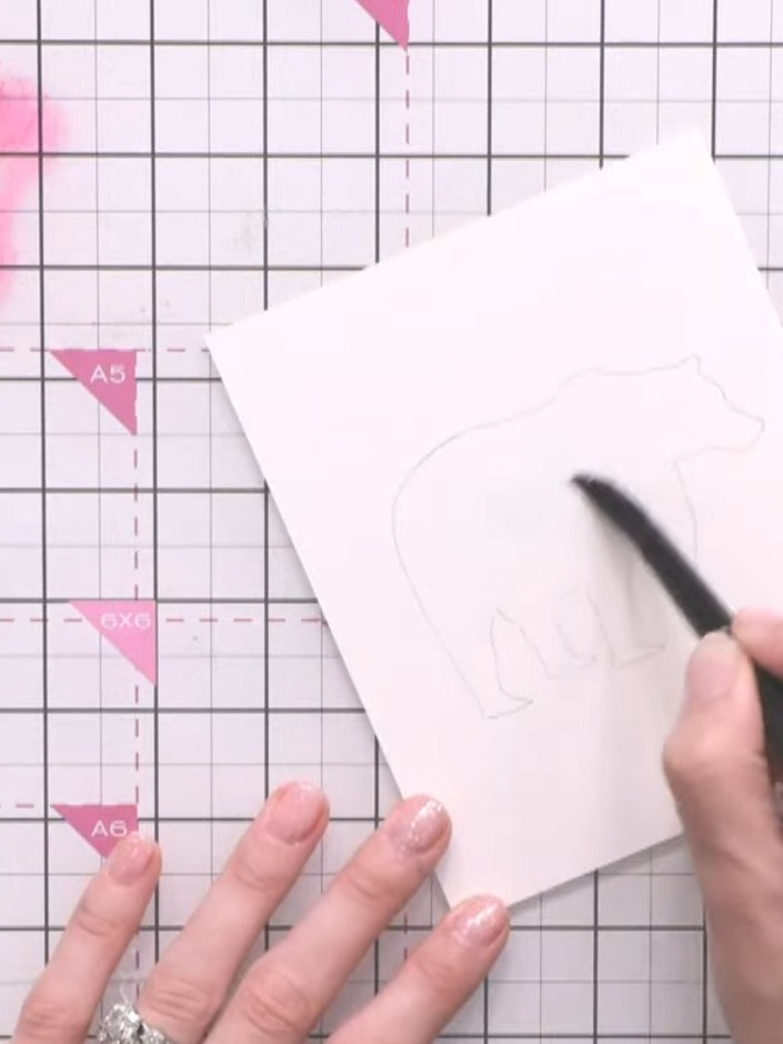 Step 3: Using a brush, paint clean water inside the bear outline on the watercolour paper, keeping the water within th