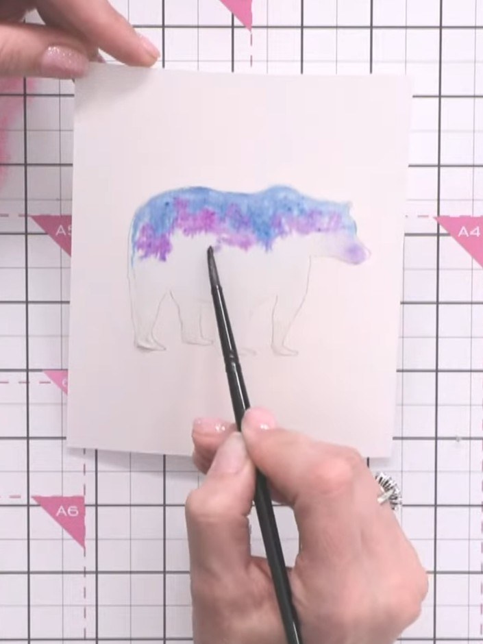 Step 7: Using a fine tip paintbrush, add darker blue ink (Indigo or Ocean) to the bear's feet and along the edges of t