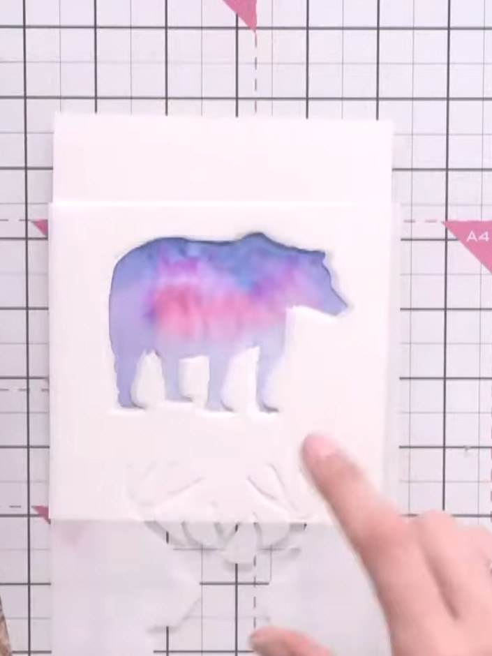 Step 9: Using the Woodland Wildlife stamp set and black ink, stamp tree images onto the lower portion of the bear silh
