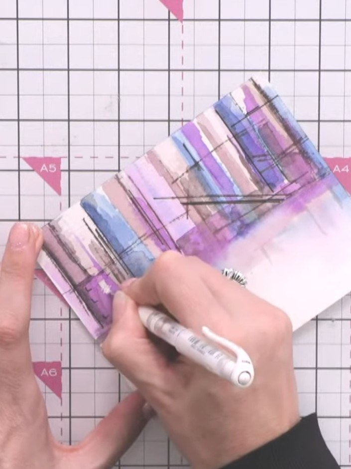 Step 11: Use a white gel pen to add highlights on the cranes and buildings to bring them forward and create depth in yo