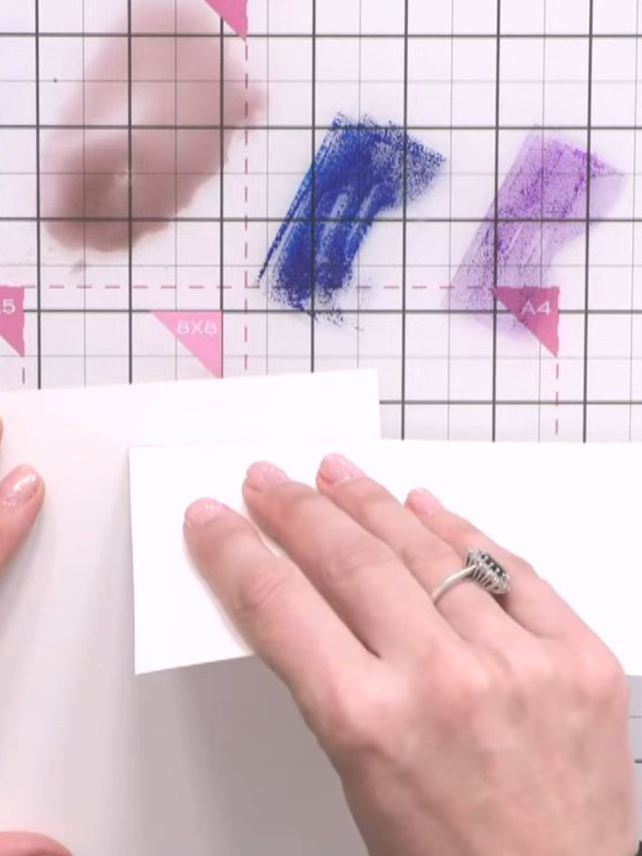 Step 4: Using blue ink pads in different shades (such as ocean and heather), apply ink strokes at varying heights acro