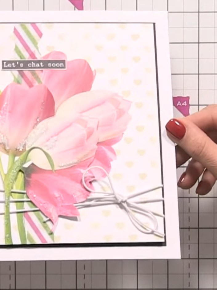 Step 10: Review the completed card, checking that all elements are securely attached and the design is balanced. The wa