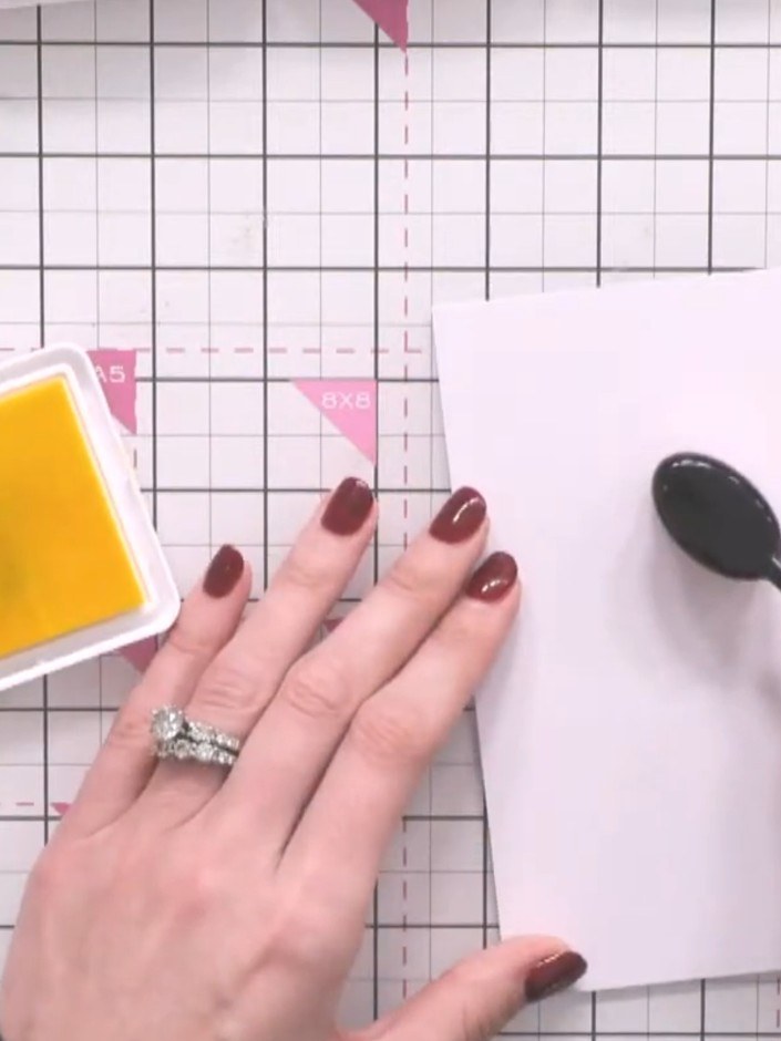 Step 3: Apply yellow ink pad to the centre of your card in a circular motion to create the sun's core.