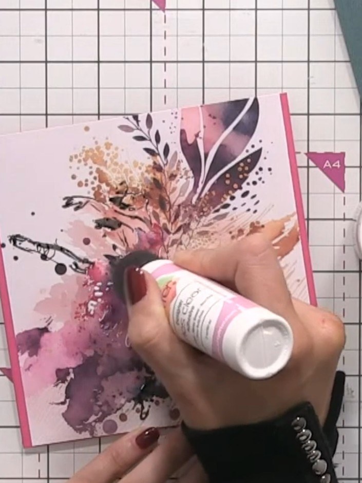 Step 9: Apply clear glass-like sparkle glitter spray to the bottom of the dress and around the figure, creating a shim