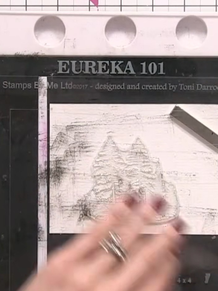 Step 3: Repeat stamping the tree silhouette several times across the white card panel, varying the heights to create a