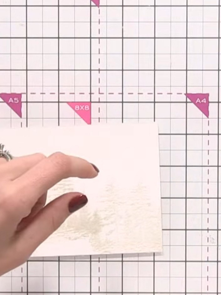 Step 4: Wet your paintbrush with clean water and dampen the area where you've stamped the first tree, following the wa
