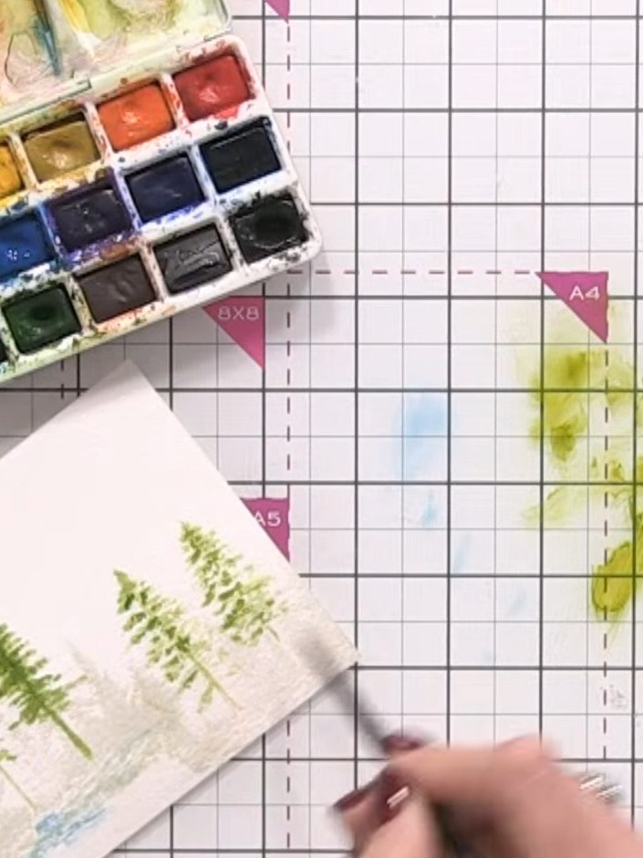 Step 8: Once the trees are completely dry, wet the entire card background with clean water using a brush to prepare fo