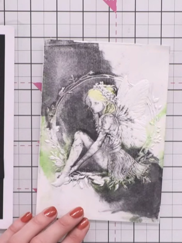 Step 10: Use a heat tool to completely dry the painted fairy image. Hold the heat tool over the card until all the wate