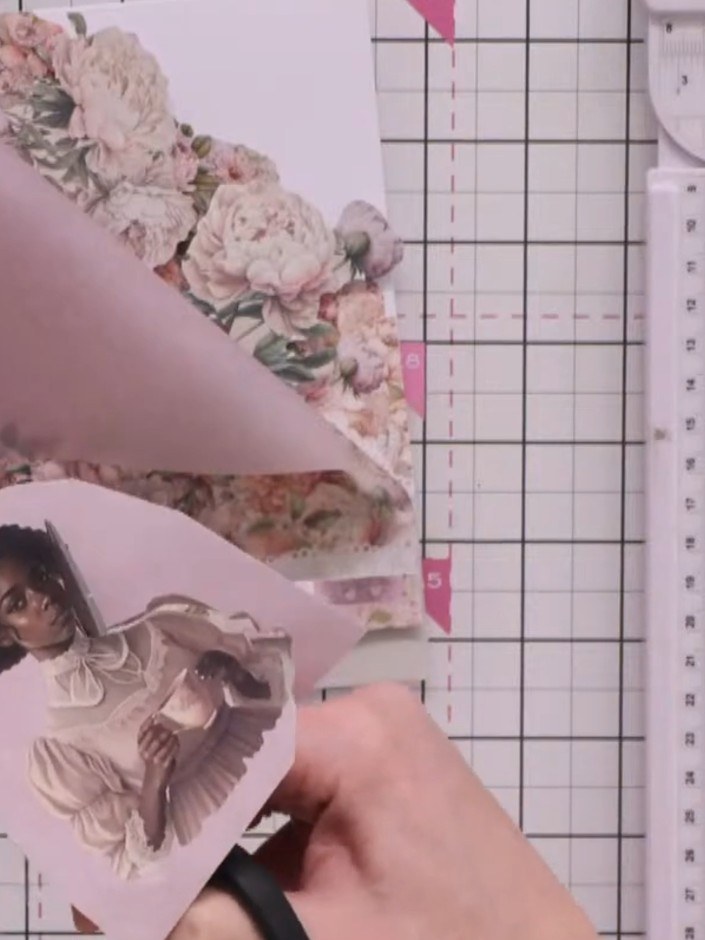 Step 10: Cut out a focal image element from the decorative paper using scissors. Position and adhere the fussy-cut imag