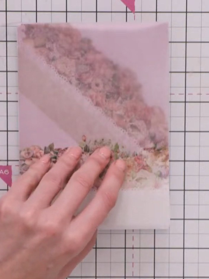 Step 4: Secure the vellum pocket to the card base with small pieces of double-sided tape placed underneath the floral 