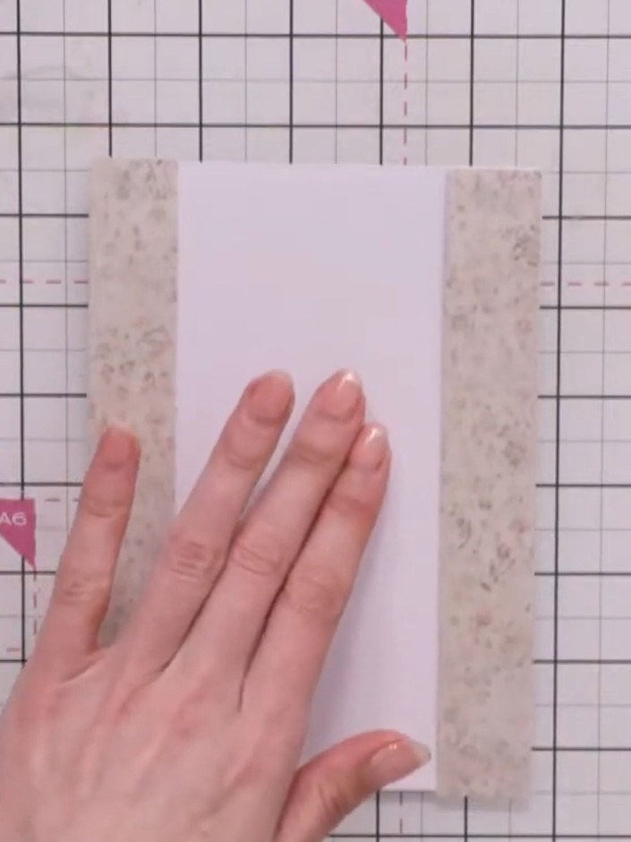Step 3: Position the second decorative paper strip down the right side of the card front, aligning it carefully with t