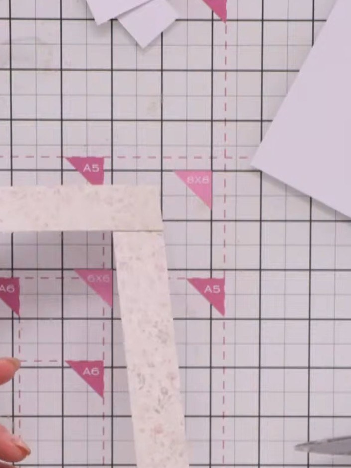 Step 6: Trim away the excess patterned paper at the corners using scissors, cutting from the outer point to the inner 