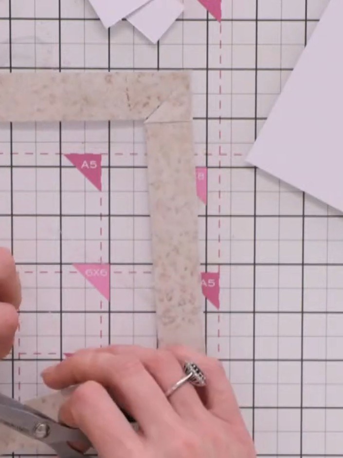 Step 7: Remove the temporary tape pieces from the frame. Discard the trimmed corner pieces.