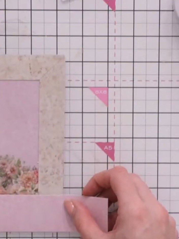 Step 2: Secure the bottom pink panel to the card base using foam pads to create dimension. Position it below the decor